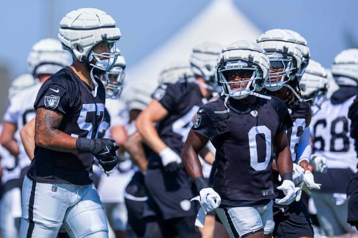 Raiders defensive end TJ Franklin (57) and cornerback Jakorian Bennett (0) run to new spots for ...