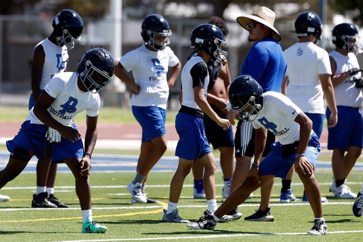 Desert Pines players stretch before the first day of high school football practice, on Monday, ...