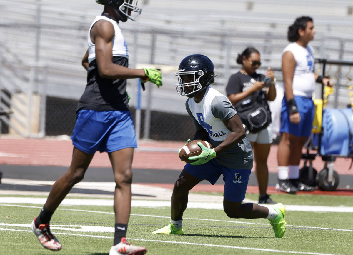 Desert Pines wide receiver Jahmih Harrison runs with the ball during the first day of high scho ...