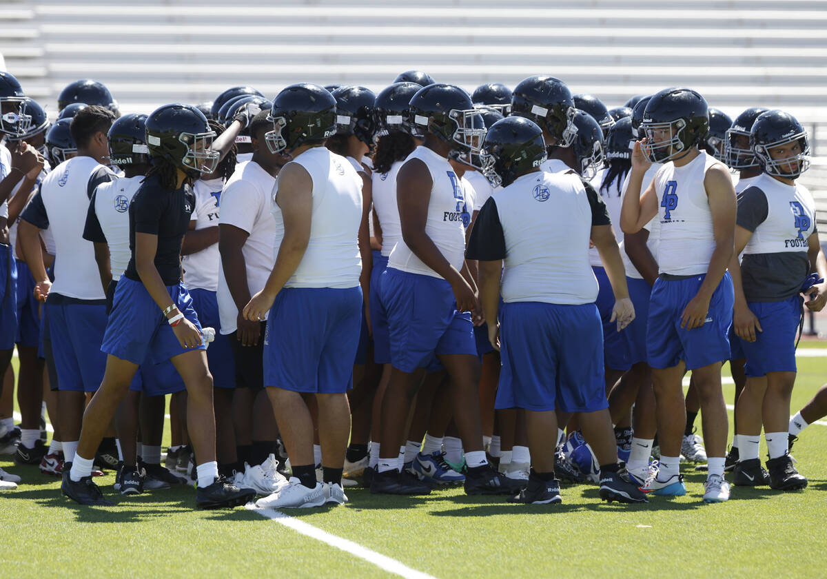 Desert Pines players huddle before the first day of high school football practice, on Monday, J ...