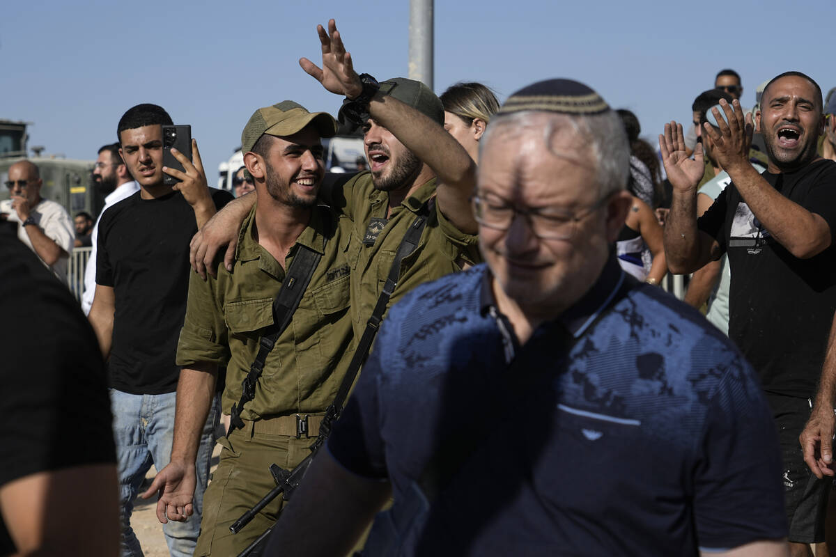 Israeli soldiers going a protest at the gate to Sde Teiman military base, in support of soldier ...