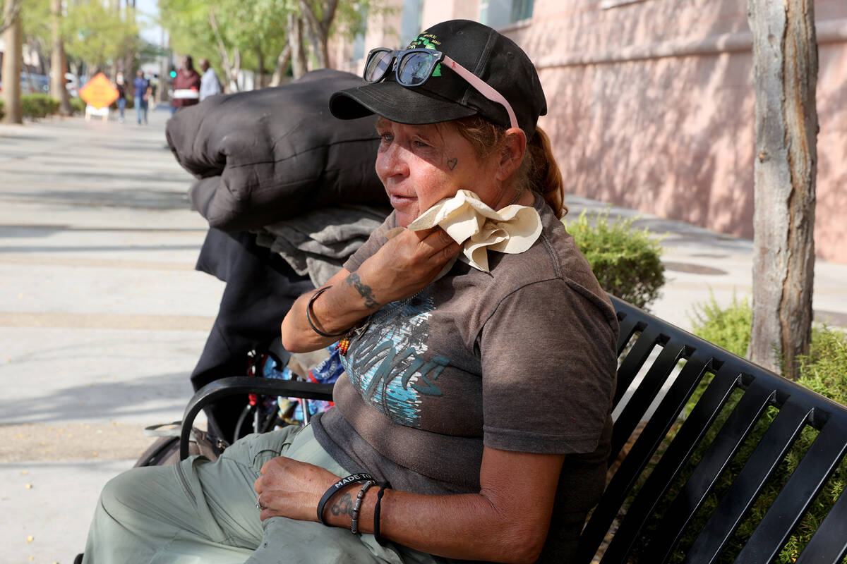 Alice "Allie" Patz wipes sweat on Third Street in front of the Regional Justice Center in downt ...