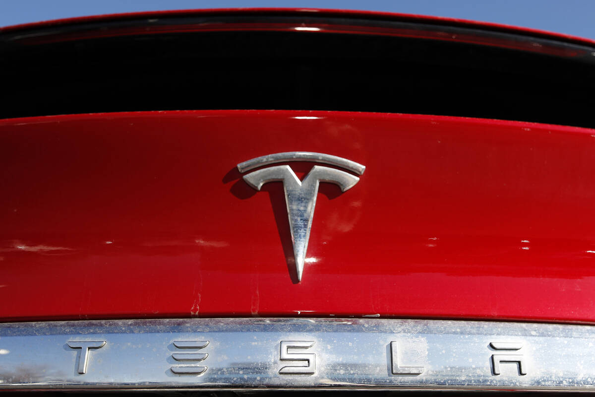 The Tesla logo appears on an unsold 2020 Model X at a dealership, Feb. 2, 2020, in Littleton, C ...