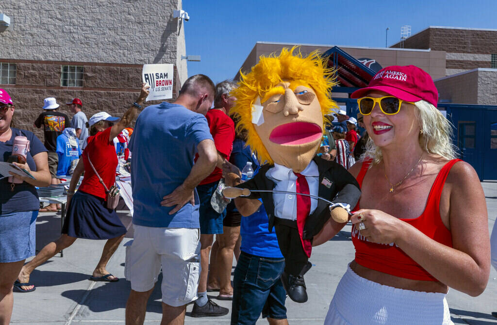 Ventriloquist April Brucker works the crowd outside with her former-President Donald Trump char ...