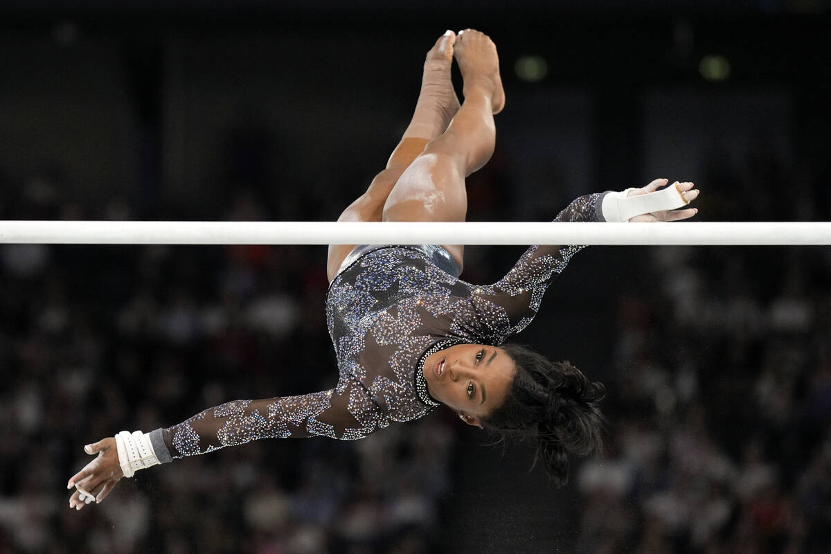 Simone Biles, of United States, competes on the uneven bars during a women's artistic gymnastic ...