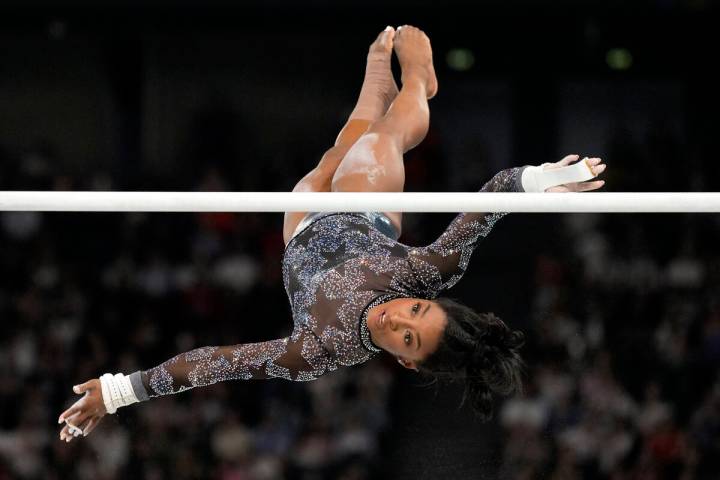 Simone Biles, of United States, competes on the uneven bars during a women's artistic gymnastic ...