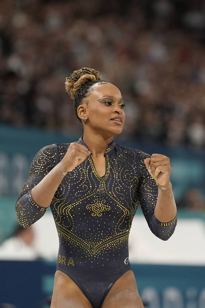 Rebeca Andrade, of Brazil, celebrates after performing on the balance beam during the women's a ...