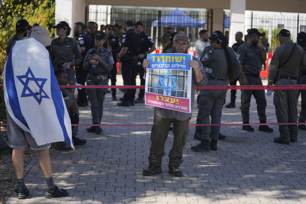 A right-wing Israelis protest outside of the initial hearing in military court for nine Israeli ...