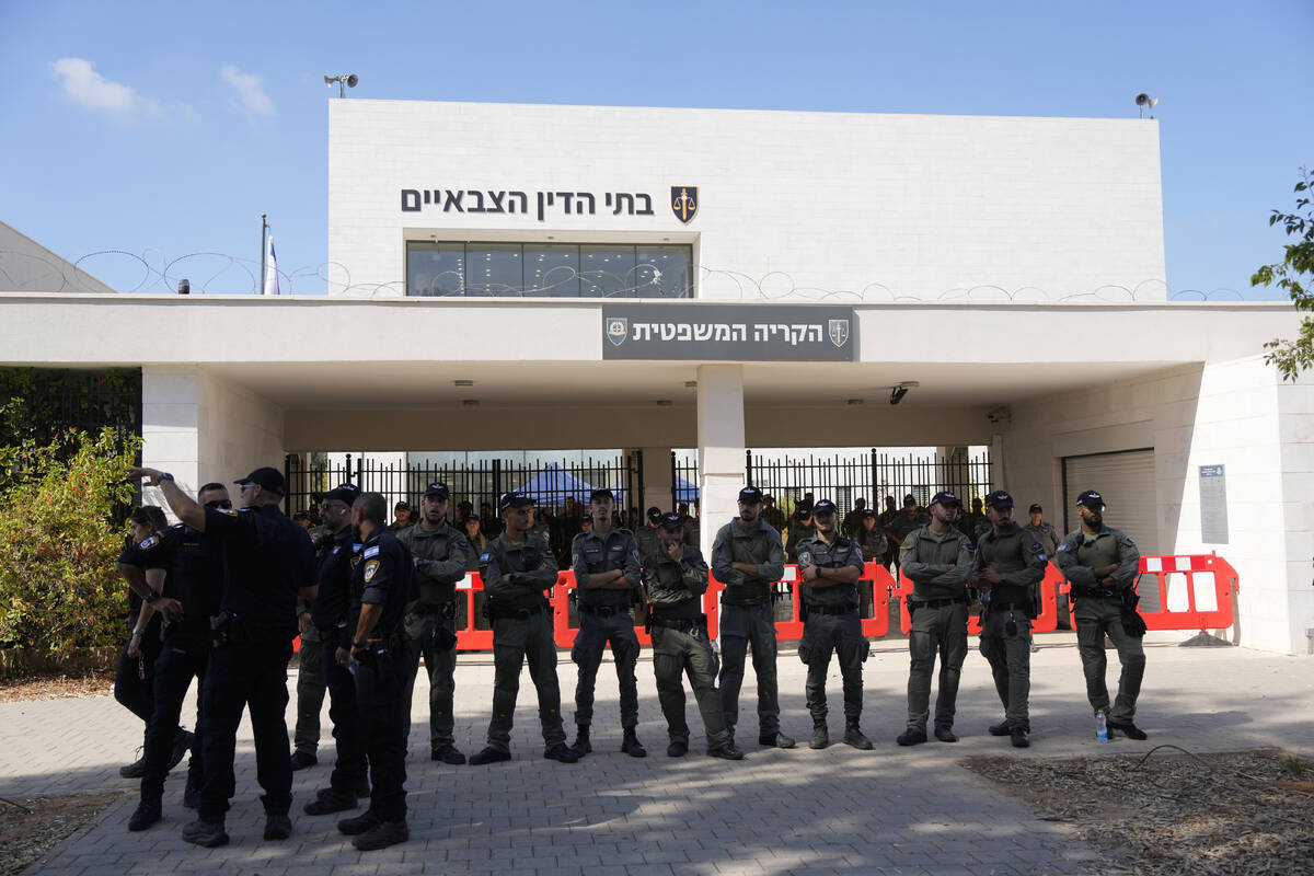 Israeli police stand guard during a right-wing protest outside of the initial hearing in milita ...