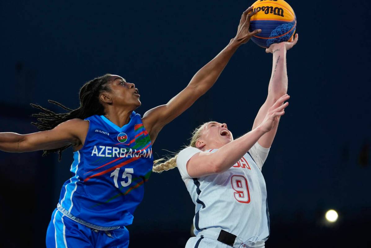 Azerbaijan's Tiffany Hayes defends against a shot by Hailey van Lith of the United States in th ...