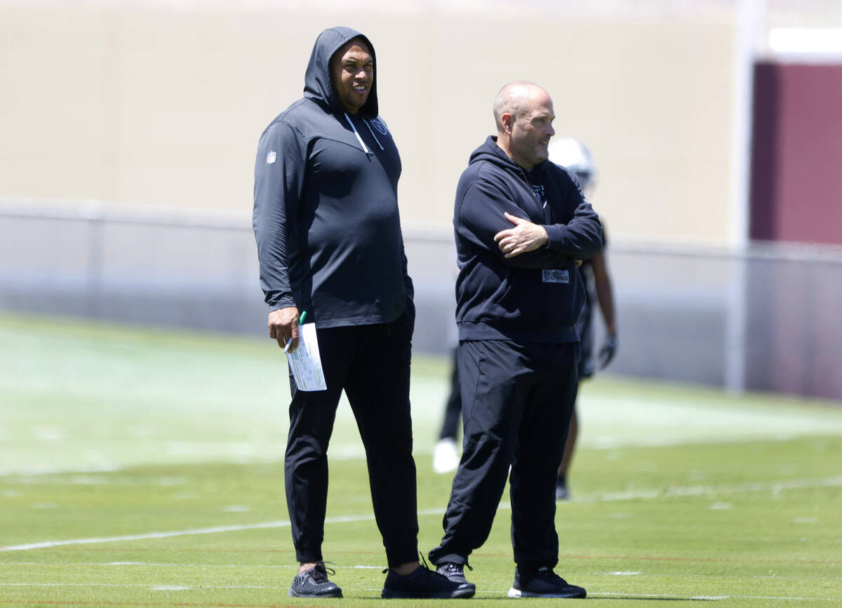 Raiders head coach Antonio Pierce, left, and special teams coordinator Tom McMahon watch their ...