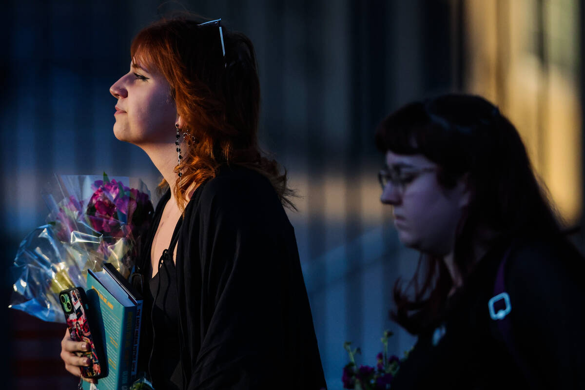 Mourners gather during a vigil for Kameron Moore and Vincent Herrera at the Riverbend Village A ...