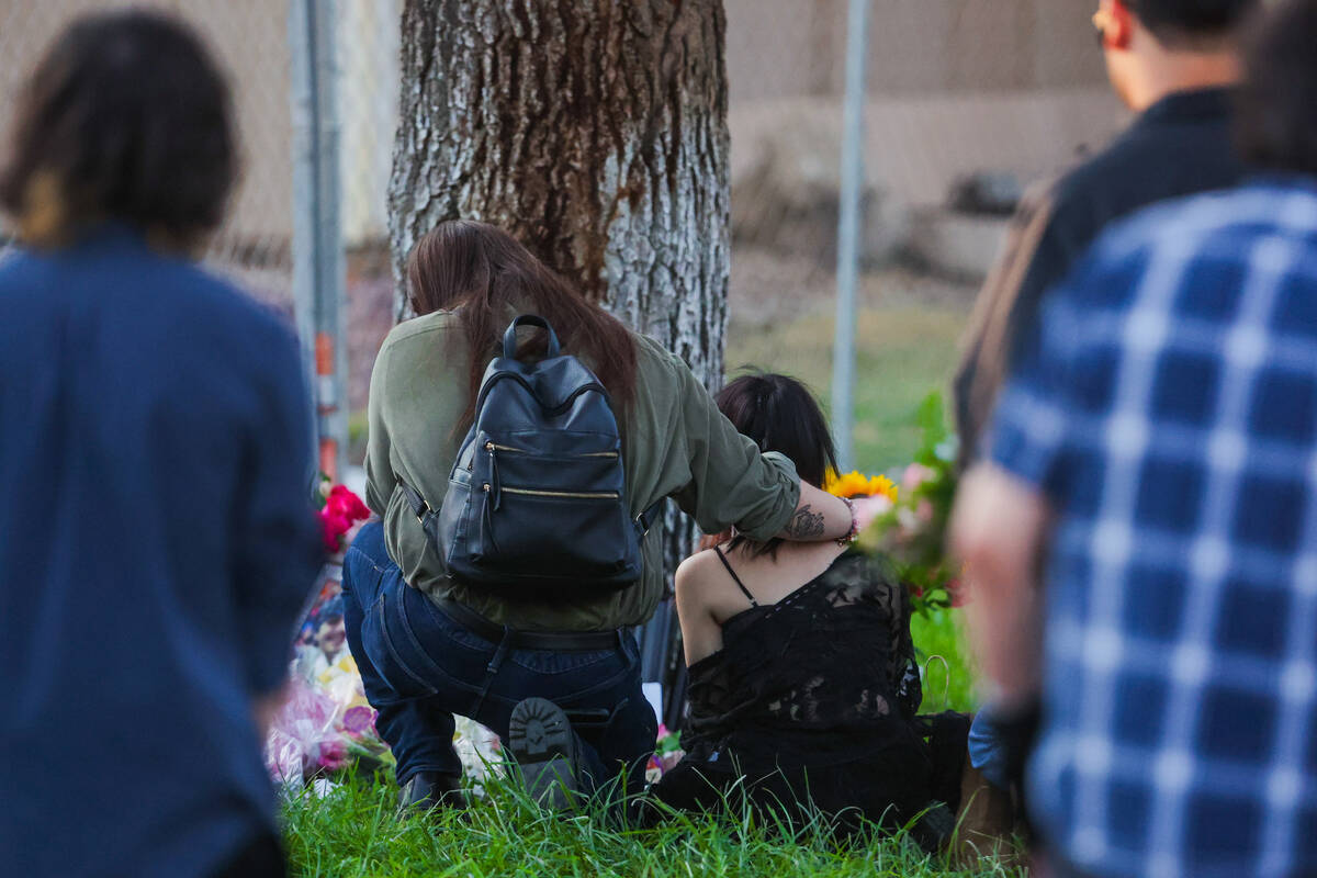 Mourners gather during a vigil for Kameron Moore and Vincent Herrera at the Riverbend Village A ...