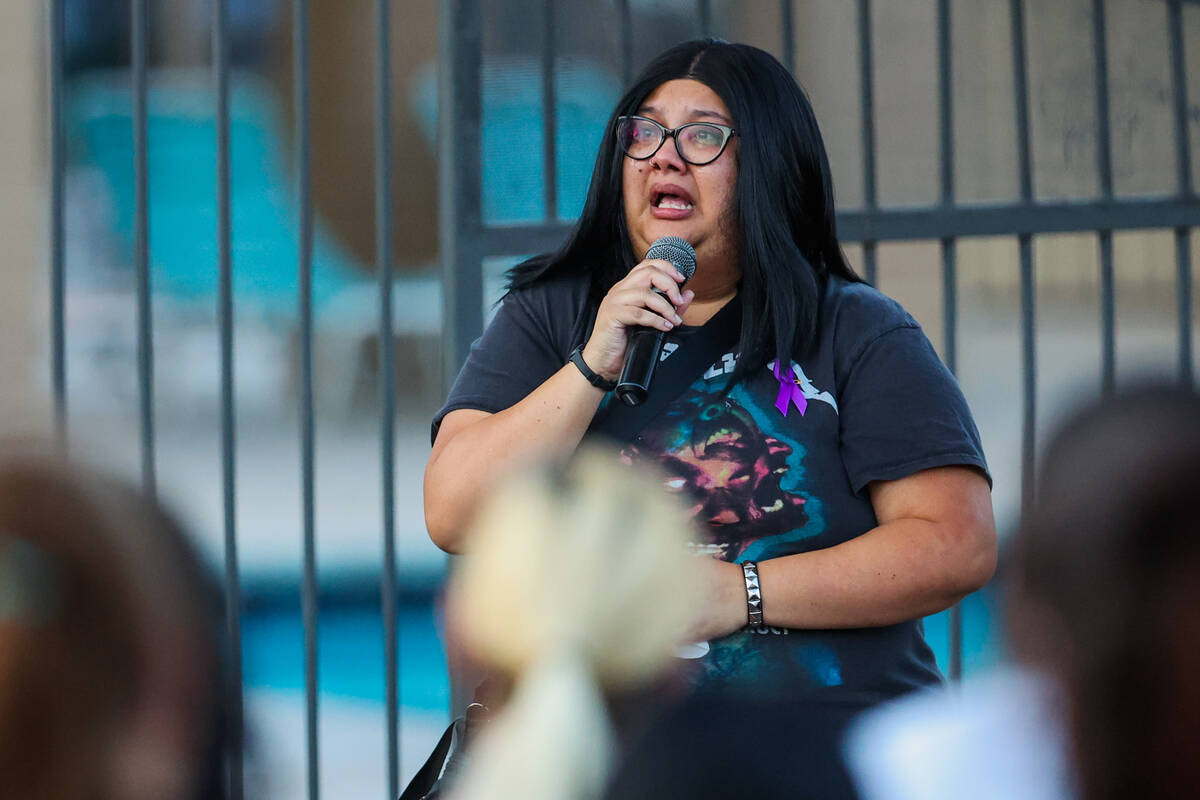 A mourner speaks during a vigil for Kameron Moore and Vincent Herrera at the Riverbend Village ...