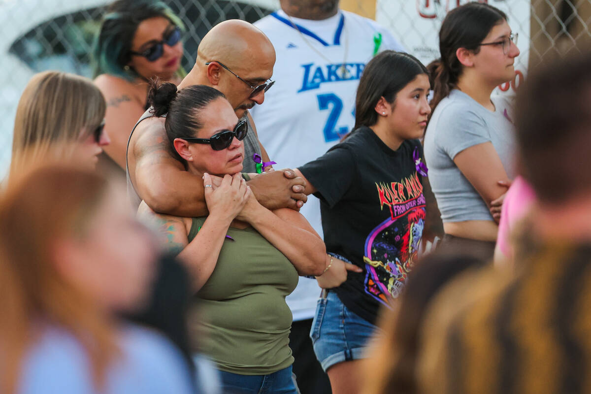 Mourners gather during a vigil for Kameron Moore and Vincent Herrera at the Riverbend Village A ...