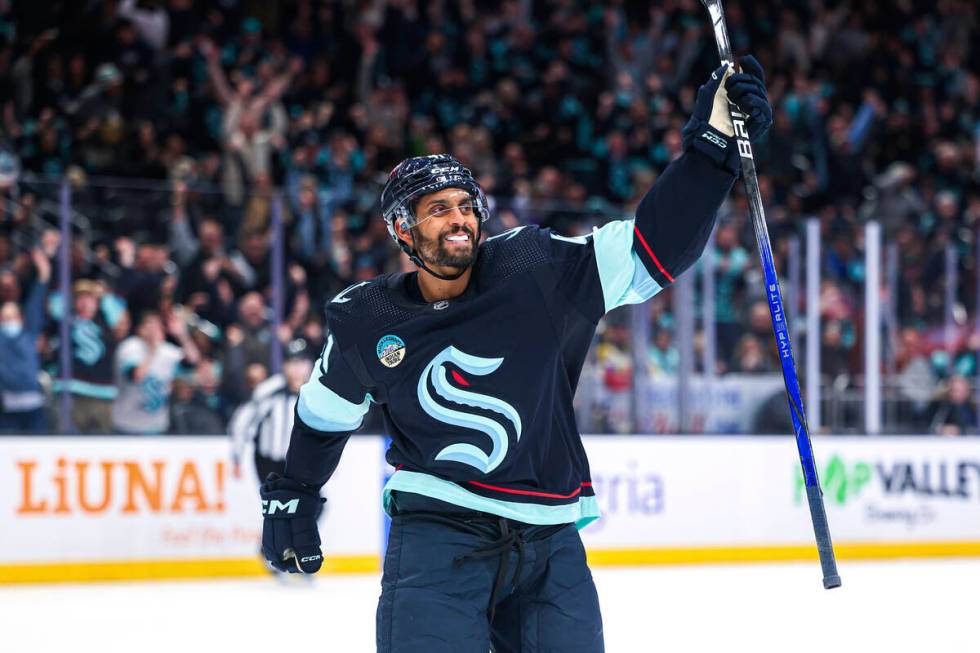 Seattle Kraken left wing Pierre-Edouard Bellemare celebrates a goal by Brandon Tanev against th ...