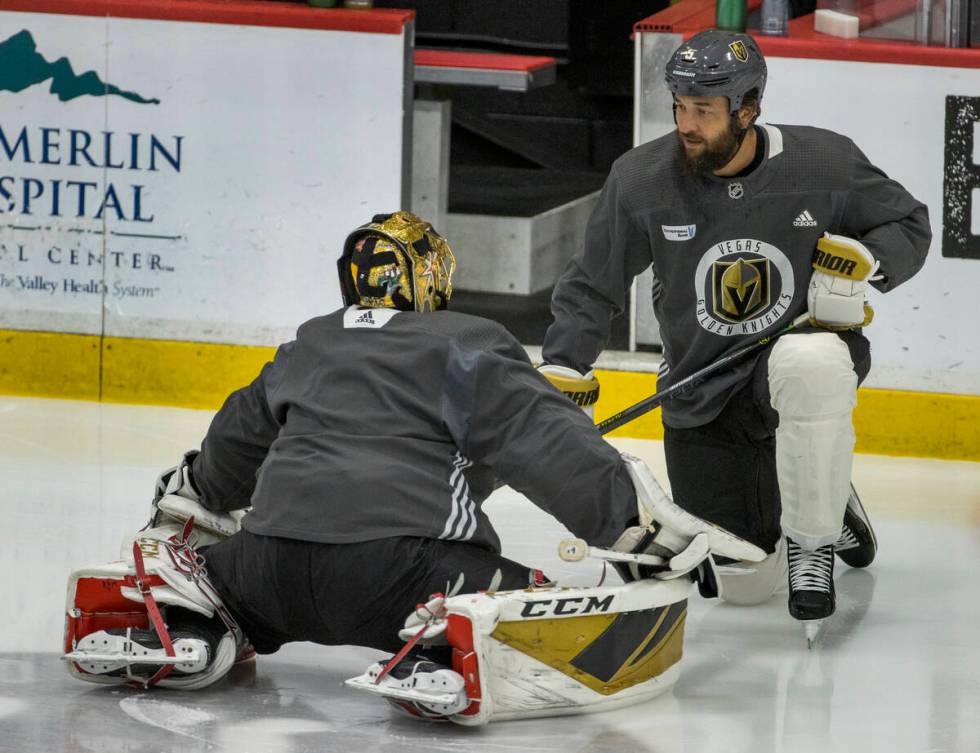 Vegas Golden Knights goaltender Marc-Andre Fleury (29, left) chats with defenseman Deryk Engell ...