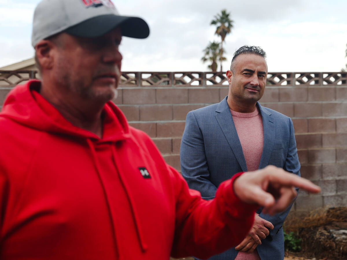 Adam Fenn of Compass Realty & Management, right, listens to Patrick King at a house in Las Vega ...