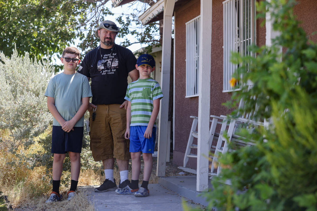 Local resident Jason Smith poses for a portrait with his children Wesson Smith, 11, left, and D ...