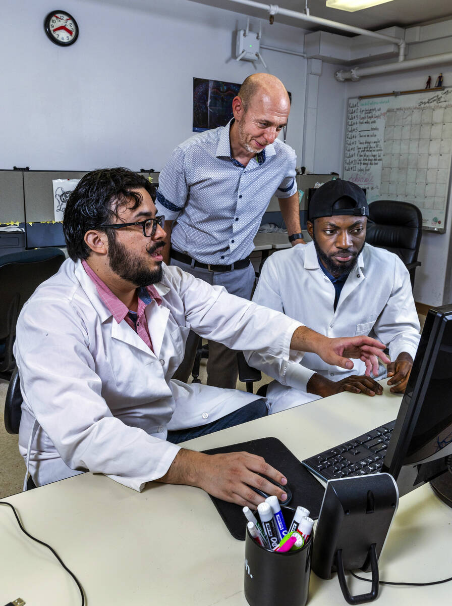 (Clockwise from top) UNLV professor James Hyman looks at data with Ph.D. students Talha Soluoku ...