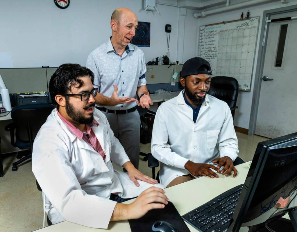 (Clockwise from top) UNLV Dr. James Hyman looks at data with Ph.D. students Talha Soluoku and E ...