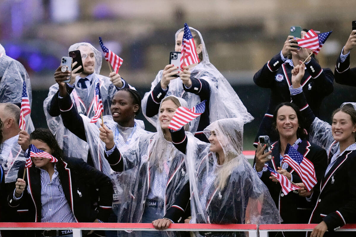 Members of the United States Team travels along the Seine River in Paris, France, during the op ...