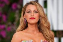 Blake Lively poses for photographers upon arrival at the UK Gala Screening for the film 'It 'En ...