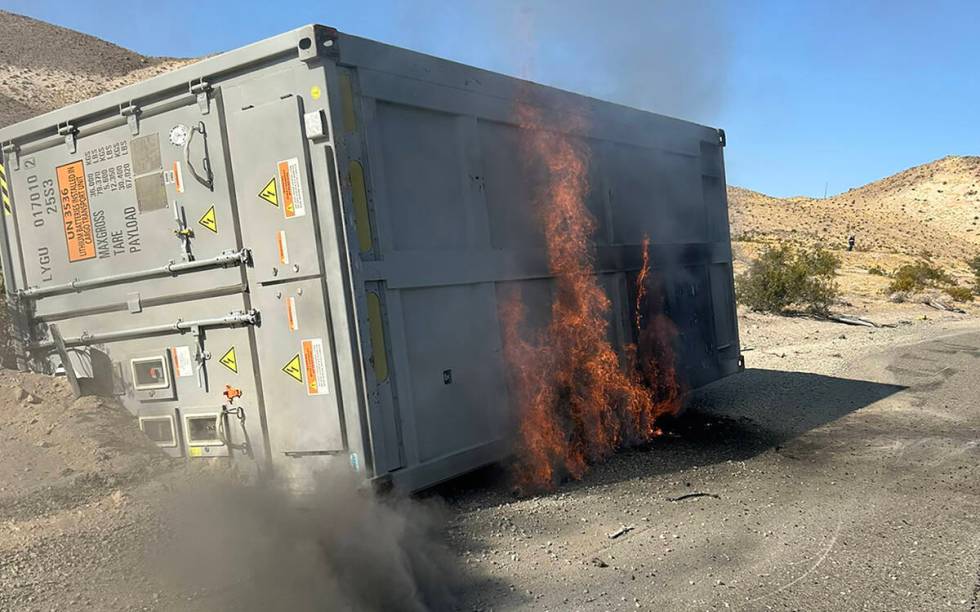 A 30-foot container, which was carrying lithium ion batteries, sits on the side of the road on ...