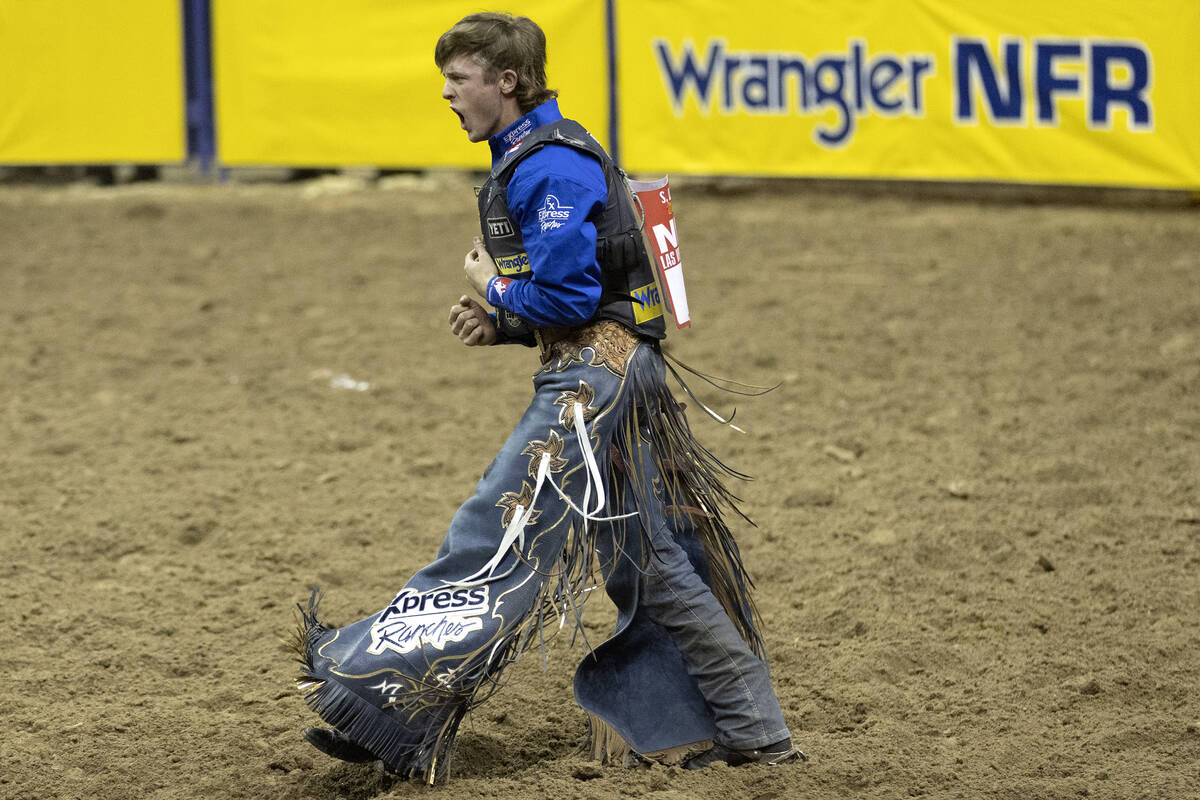 Stetson Wright, of Milford, Utah, celebrates after competing in bull riding during the eighth g ...