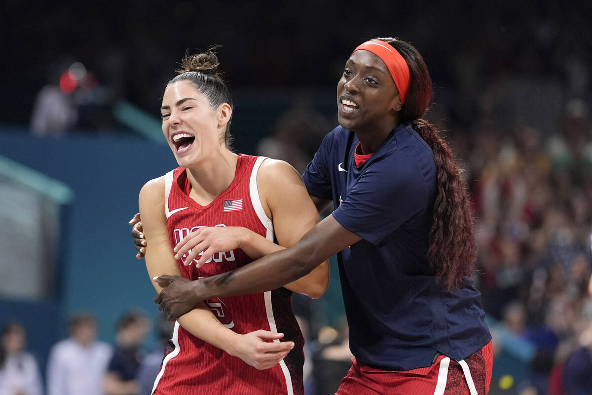 United States' Kelsey Plum, left, and United States' Kahleah Copper celebrate as they walk off ...