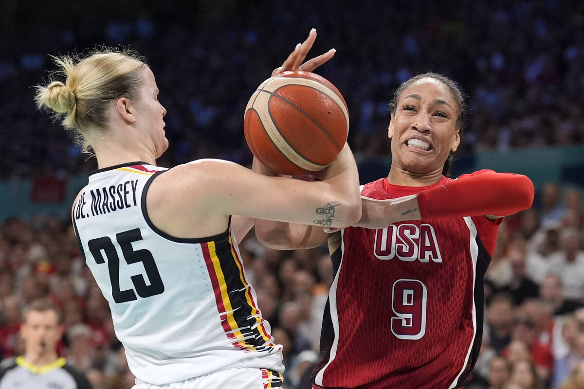 Belgium's Beckey Massey, left, and United States' A'ja Wilson grapple for the ball during a wom ...