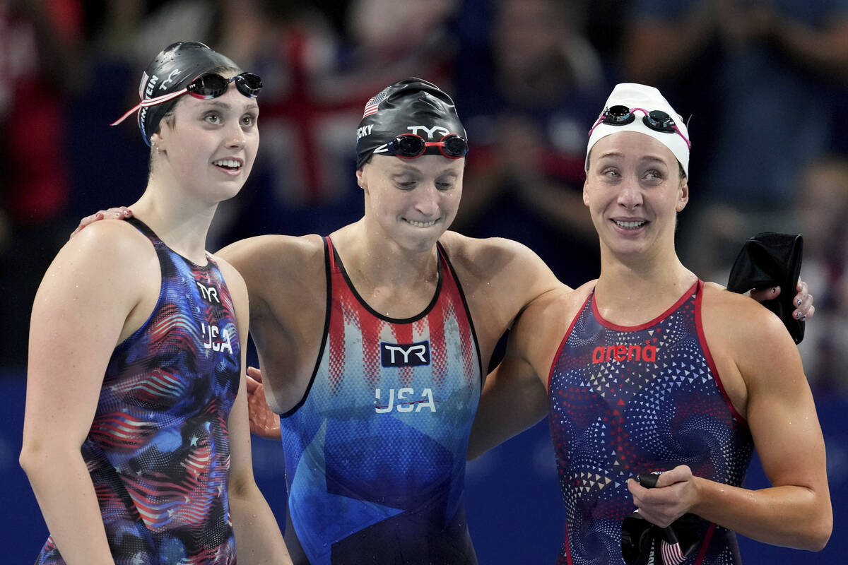 United States' Claire Weinstein, from left, Katie Ledecky and Paige Madden react as they win th ...