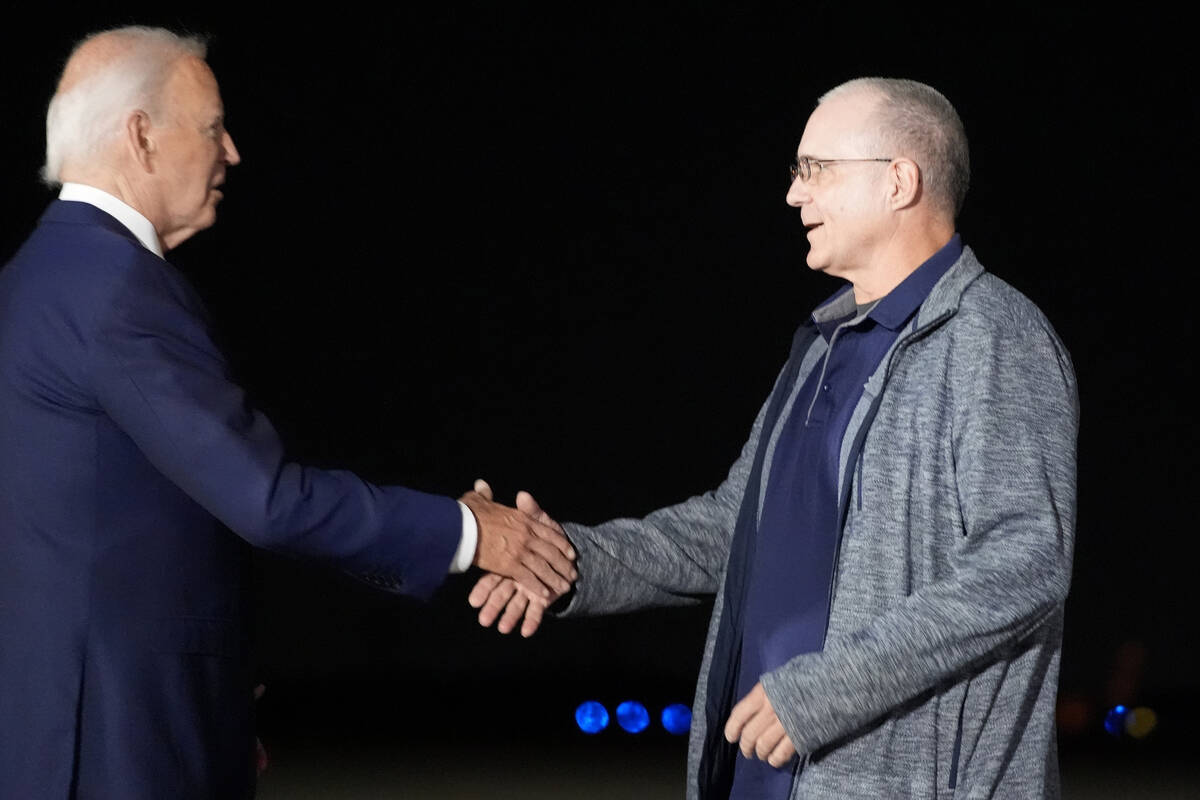 President Joe Biden, left, greets Paul Whelan at Andrews Air Force Base, Md., following his rel ...