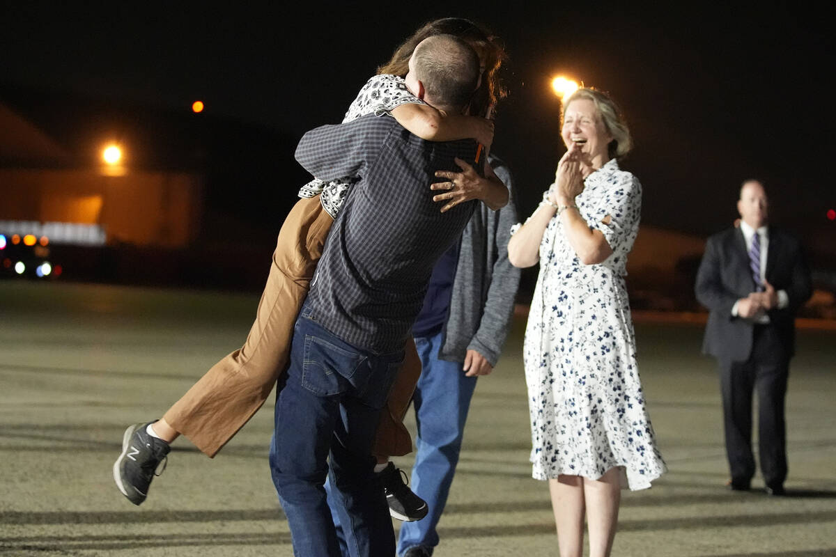 Reporter Evan Gershkovich hugs his mother Ella Milman, left, at Andrews Air Force Base, Md., fo ...