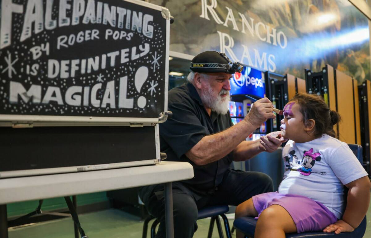 Ladinna Lucero, 5, gets her face painted during a back to school fair at Rancho High School on ...