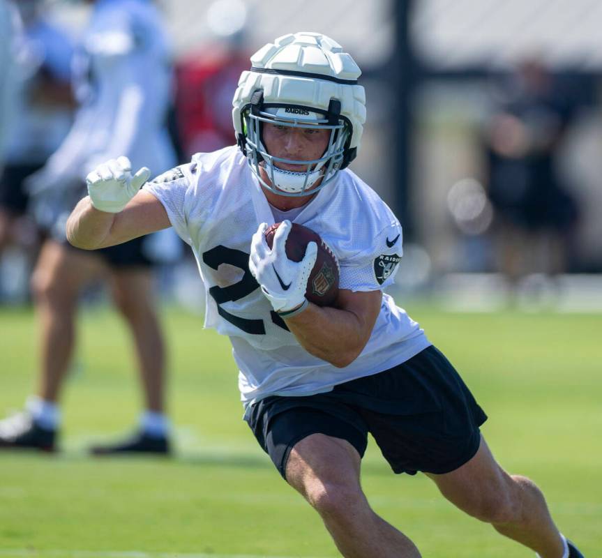 Raiders running back Dylan Laube (23) cuts arounds a coach on a drill during the second day of ...