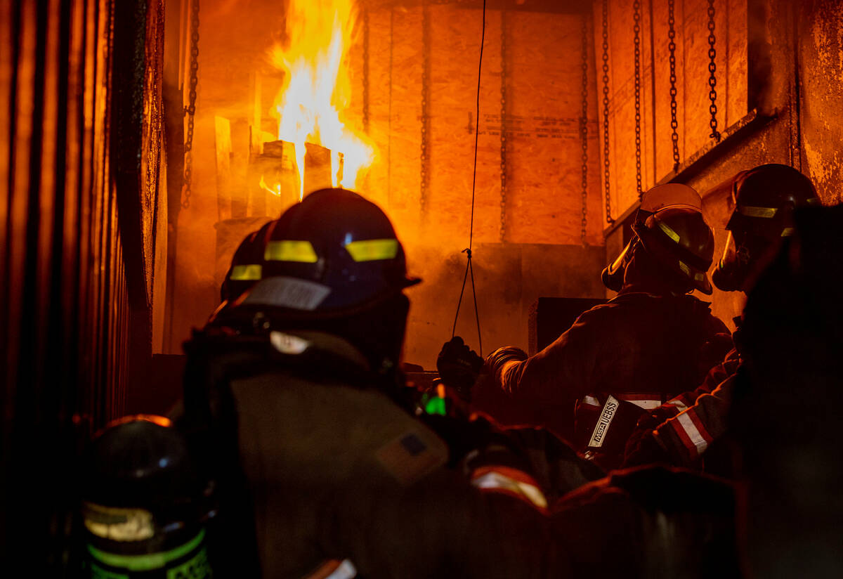 Clark County Fire Department recruits take positions within a trailer that will be overtaken wi ...