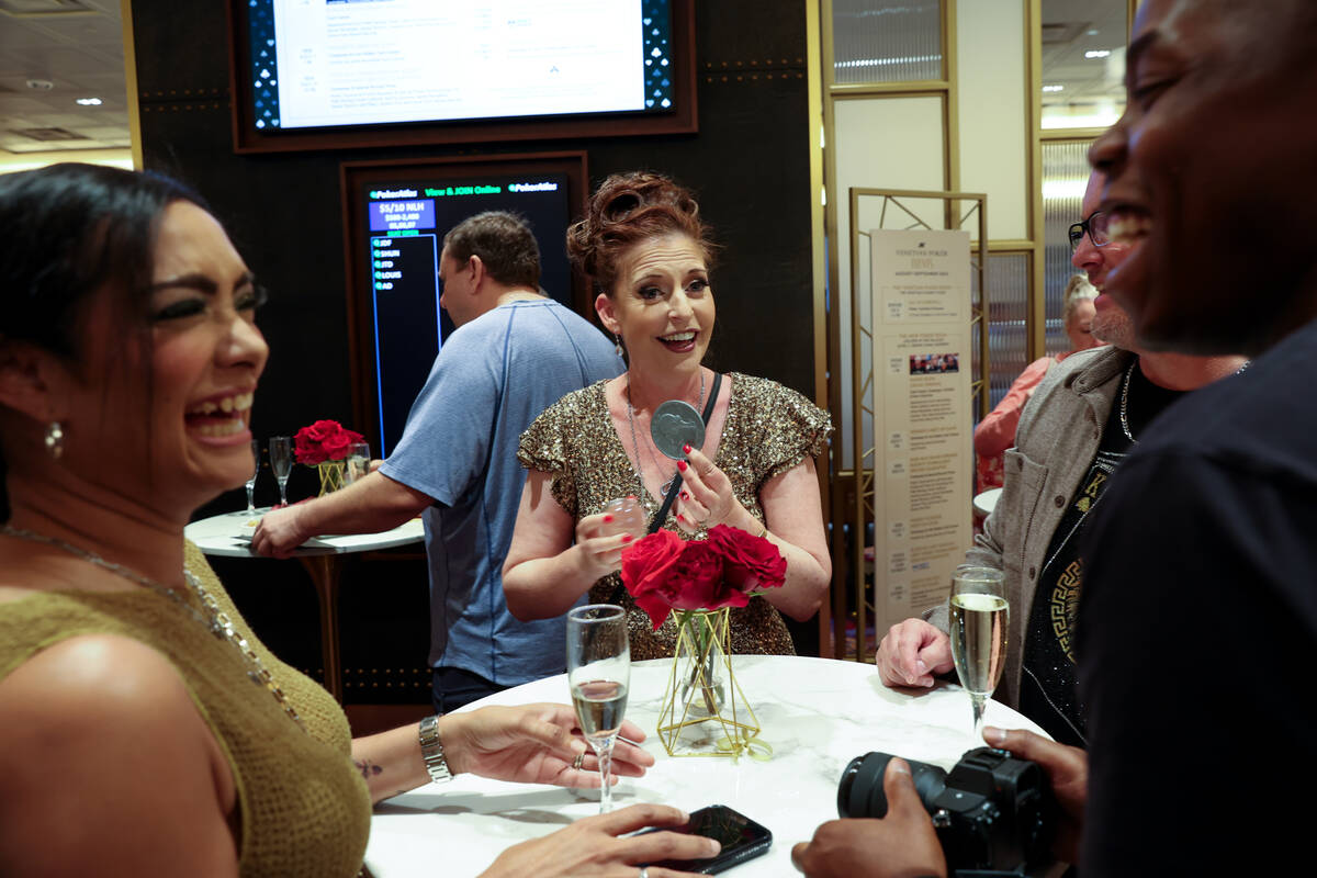 Magician Joan Dukord entertains attendees during an opening event for a new poker room In the G ...