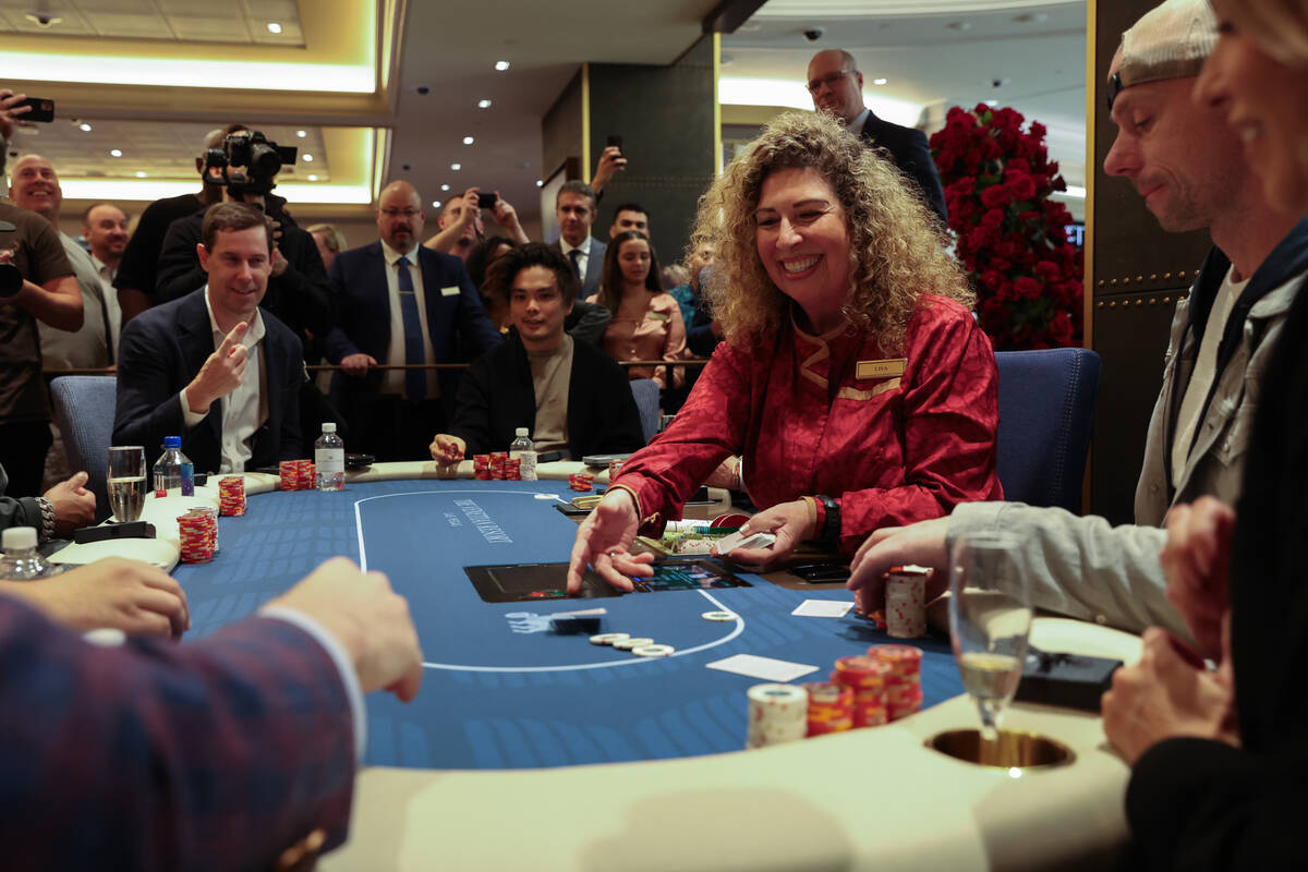 A ceremonial first hand is dealt during an opening event for a new poker room in the Grand Cana ...