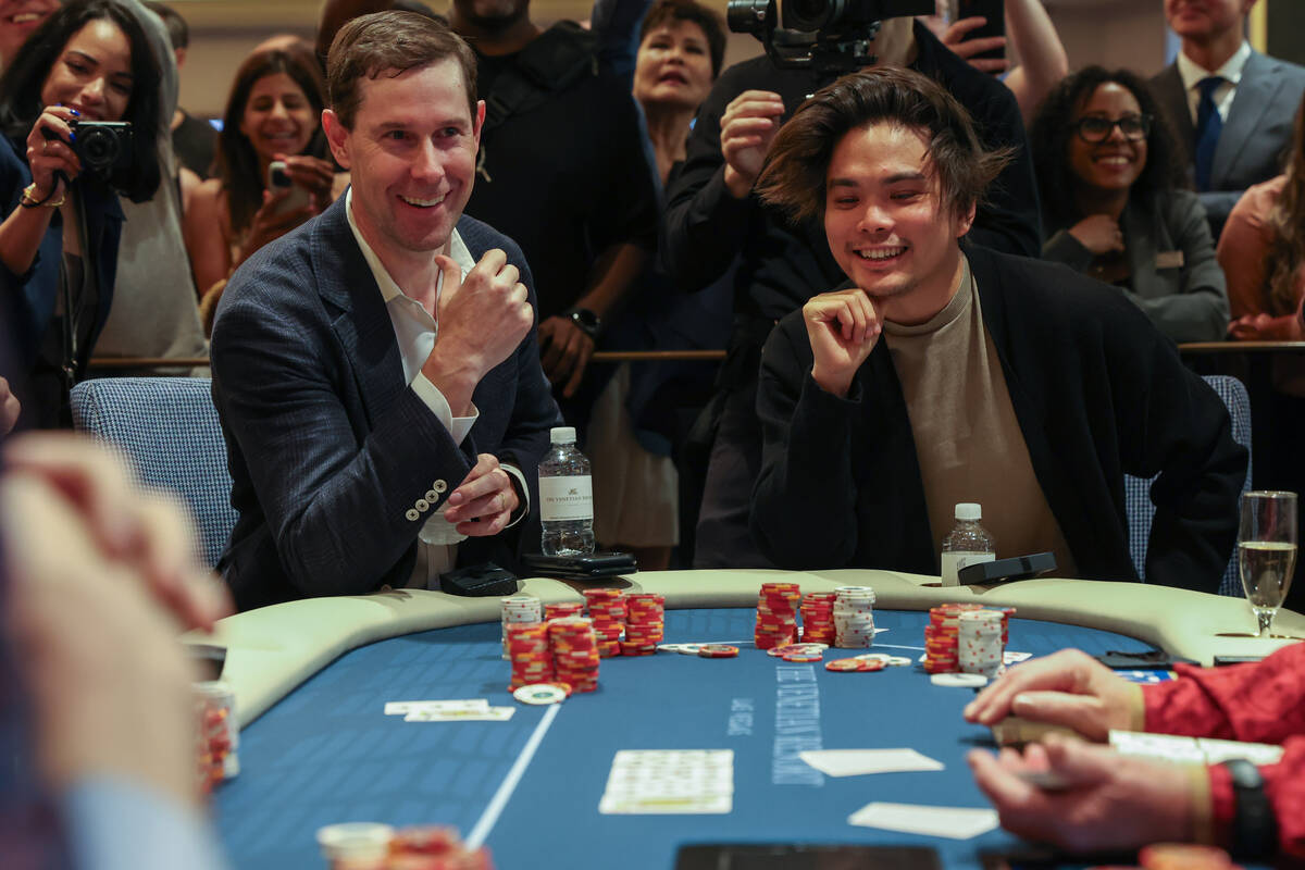 Venetian CFO Rob Brimmer, left, and magician Shin Lim, right, play a ceremonial first hand duri ...