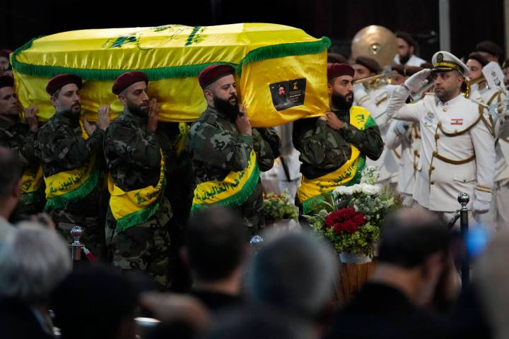 Hezbollah fighters carry the coffin of their top commander Fouad Shukur, who was killed by an I ...