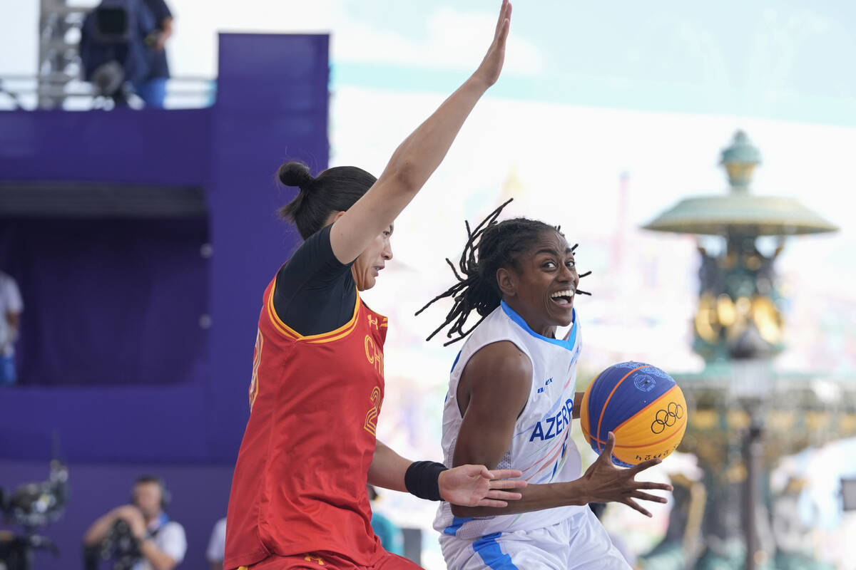 China's Wang Lili, left, defends Azerbaijan's Tiffany Hayes in the women's 3x3 basketball pool ...