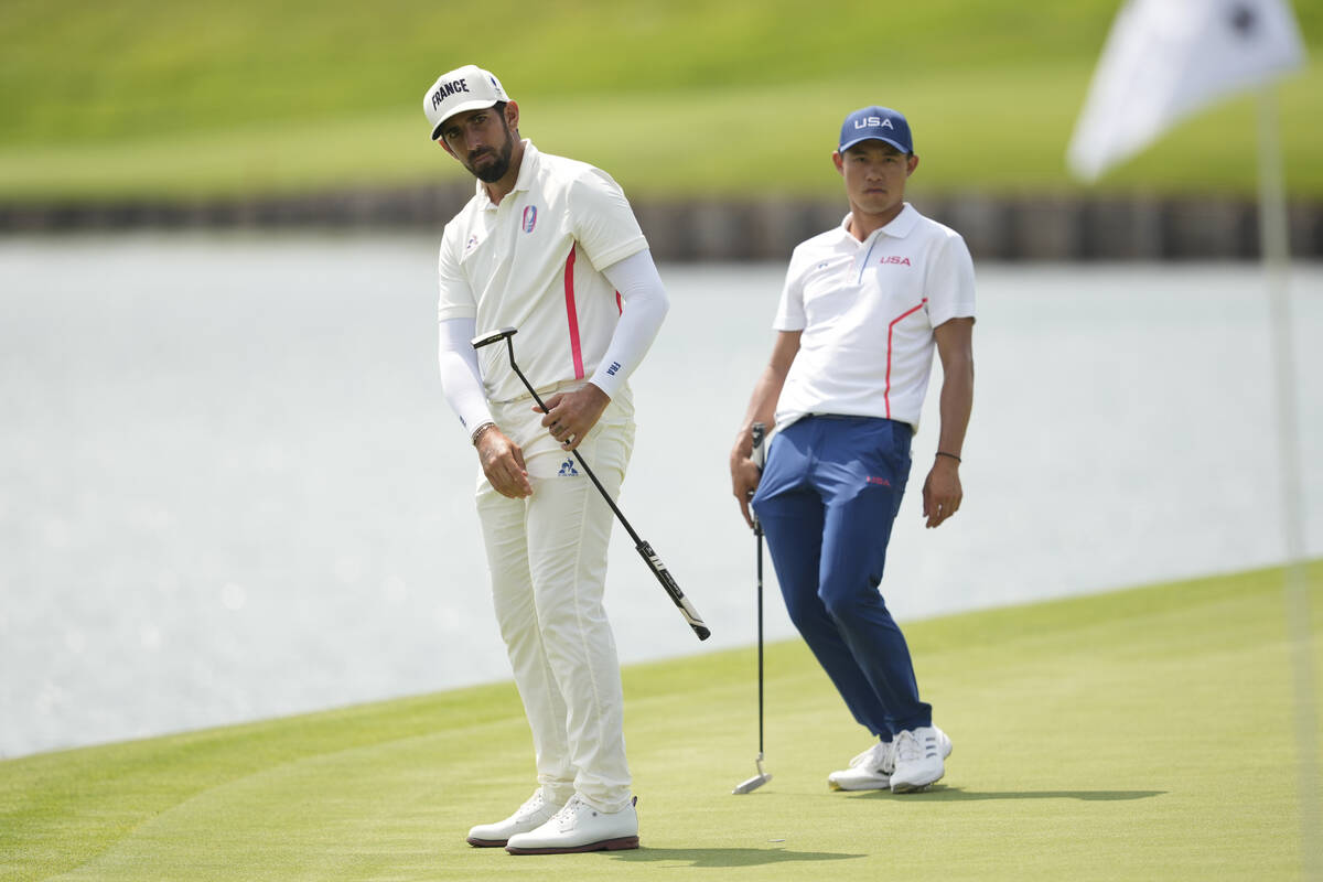 Matthieu Pavon, of France, putts and misses as Collin Morikawa, of the United States, reacts on ...