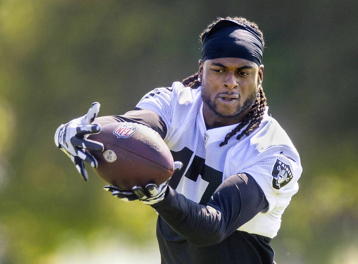 Raiders wide receiver Davante Adams (17) looks in a pass during the third day of Raiders traini ...