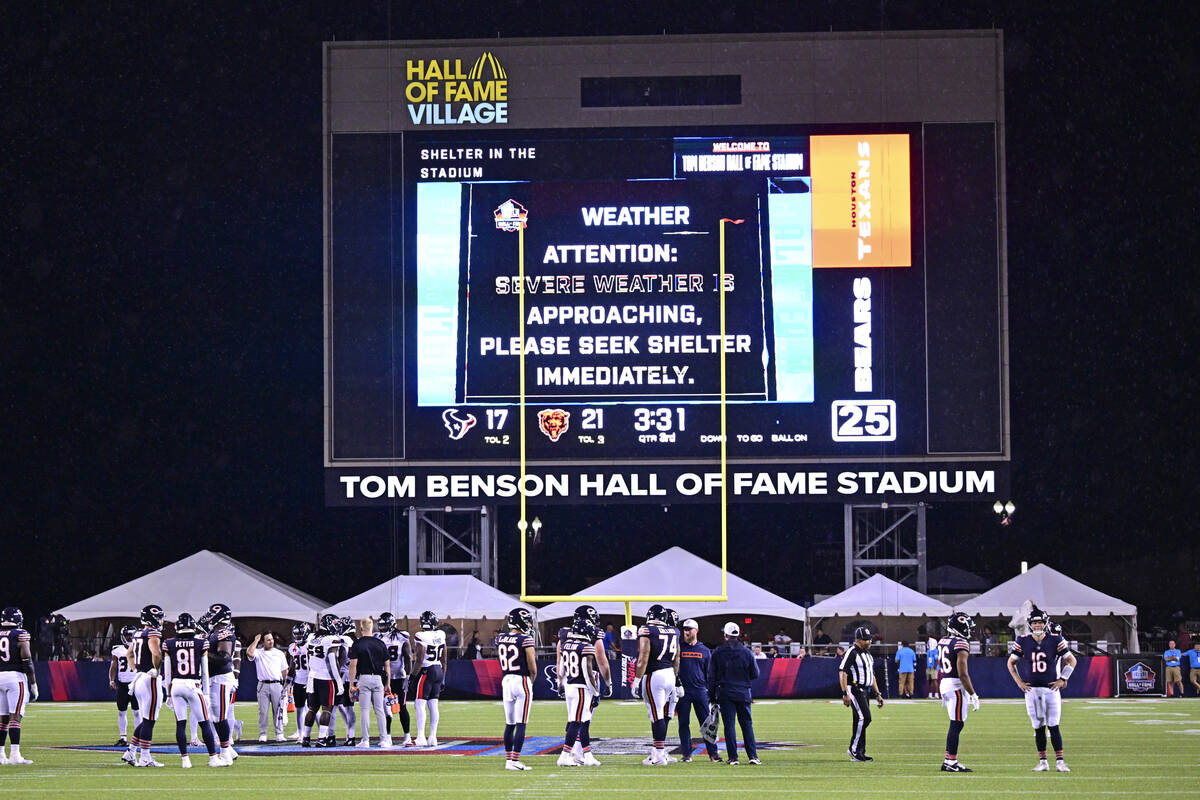 The Chicago Bears and the Houston Texans stand on the field as a delay is called during the sec ...