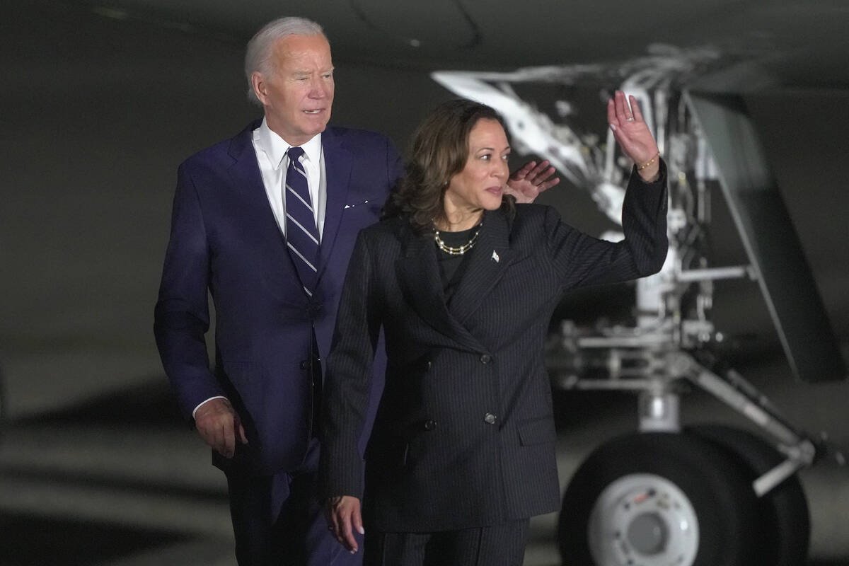 President Joe Biden and Vice President Kamala Harris walking across the tarmac after greeting r ...