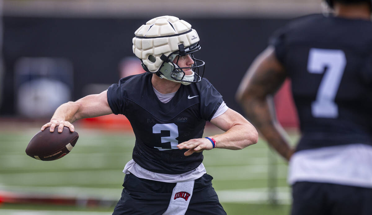 UNLV quarterback Matthew Sluka (3) eyes a receiver during the first day of football practice at ...