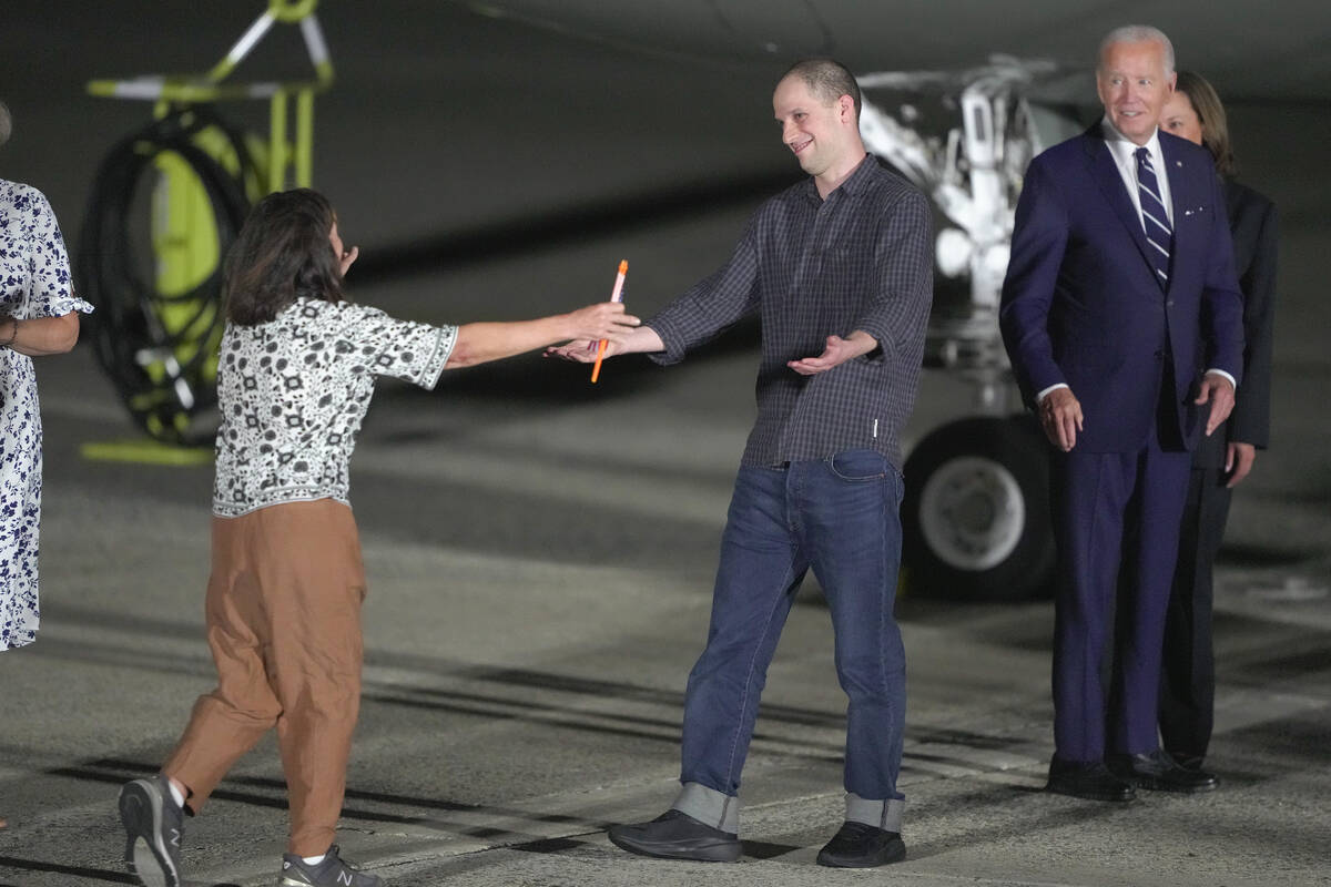 Reporter Evan Gershkovich is greeted on the tarmac by his mother, Ella Milman, as President Joe ...