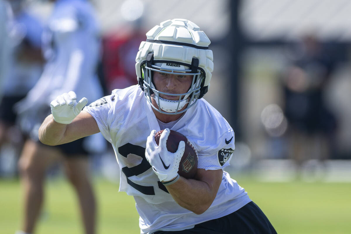 Raiders running back Dylan Laube (23) cuts arounds a coach on a drill during the second day of ...