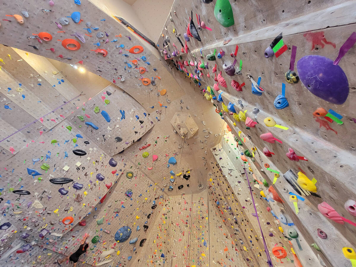 The view up 35-foot-tall climbing walls filled with colorful holds (smaller grips) and jugs (la ...